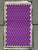 Flat lay of a grey and purple Dosha Mat acupressure mat